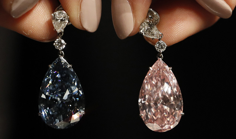 The Apollo blue diamond and the Artemis pink diamond earrings are displayed at Sotheby's auction rooms in London, Monday, April 10, 2017. The earrings, the most valuable ever to appear at auction, are estimated at 62- 87 million UK pounds (50-70 million US dollars) and will be auctioned on May 16 in Geneva. (AP Photo/Kirsty Wigglesworth)